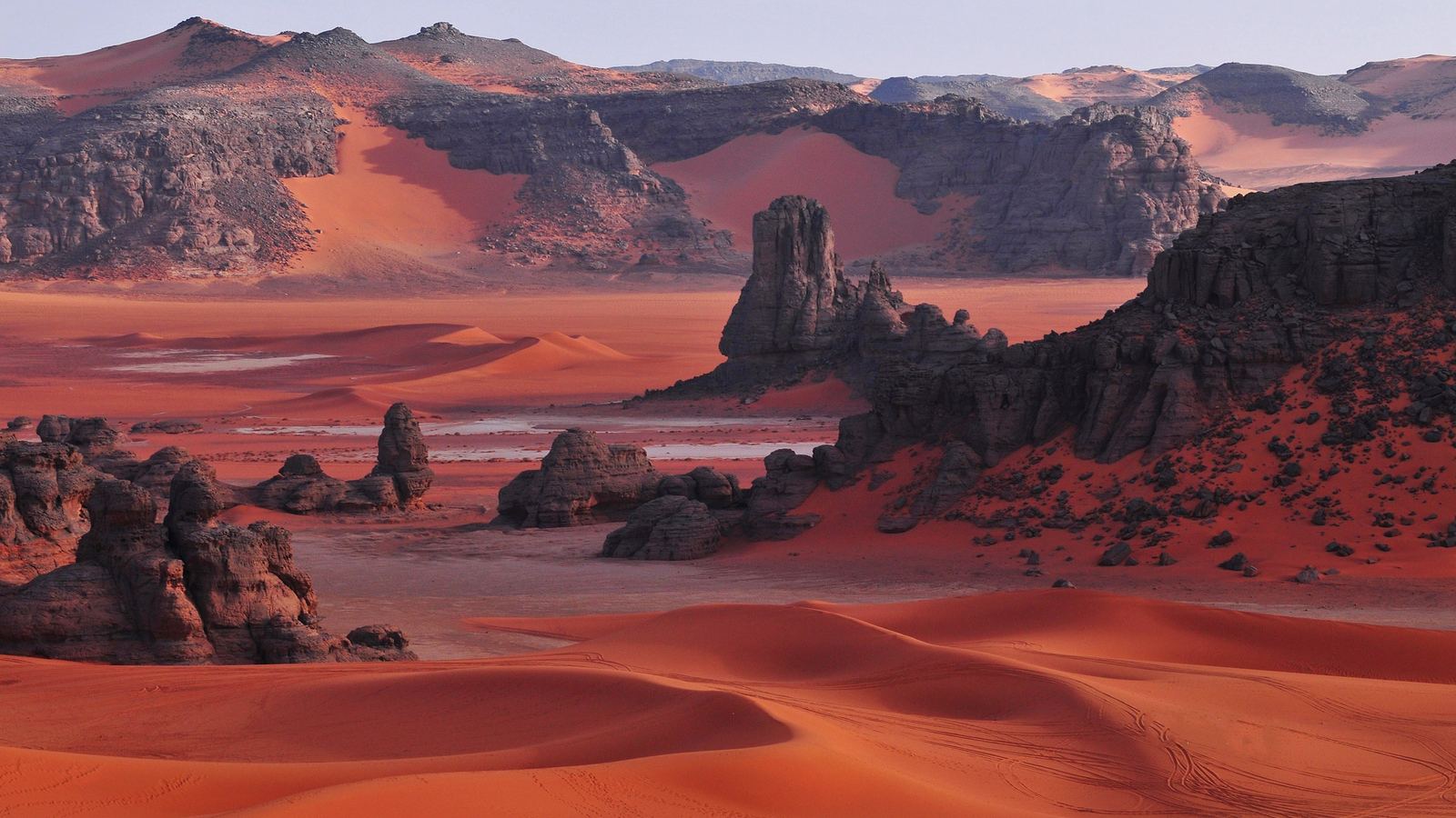 Red dunes and dark sandstone towers of the Tadrart Rouge, Tassili n'Ajjer