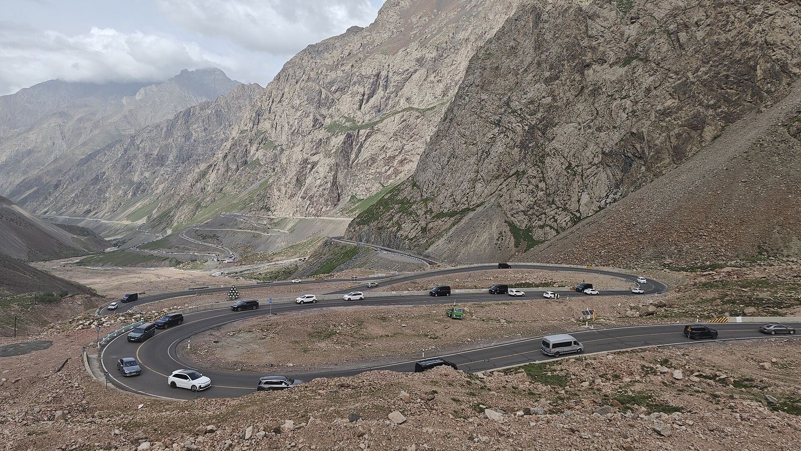 Cars climbing the hairpin bends of the Duku Highway (G217) through the Tianshan, Wusu, Xinjiang.