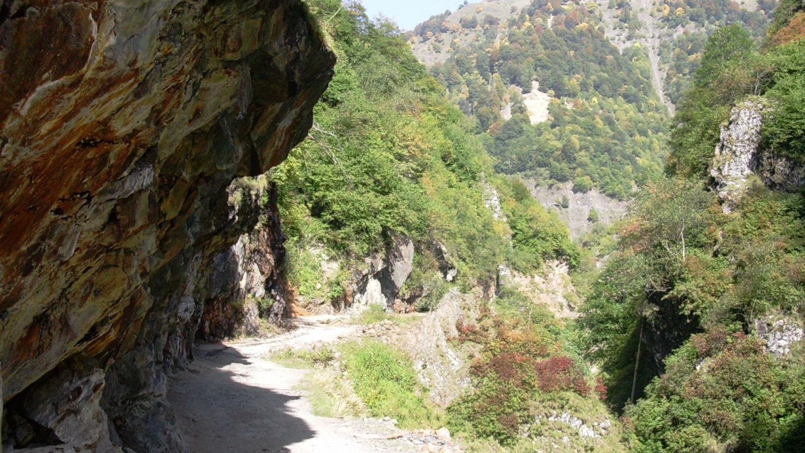 Mountain track under a rock overhang on the road to Omalo, Tusheti, Georgia