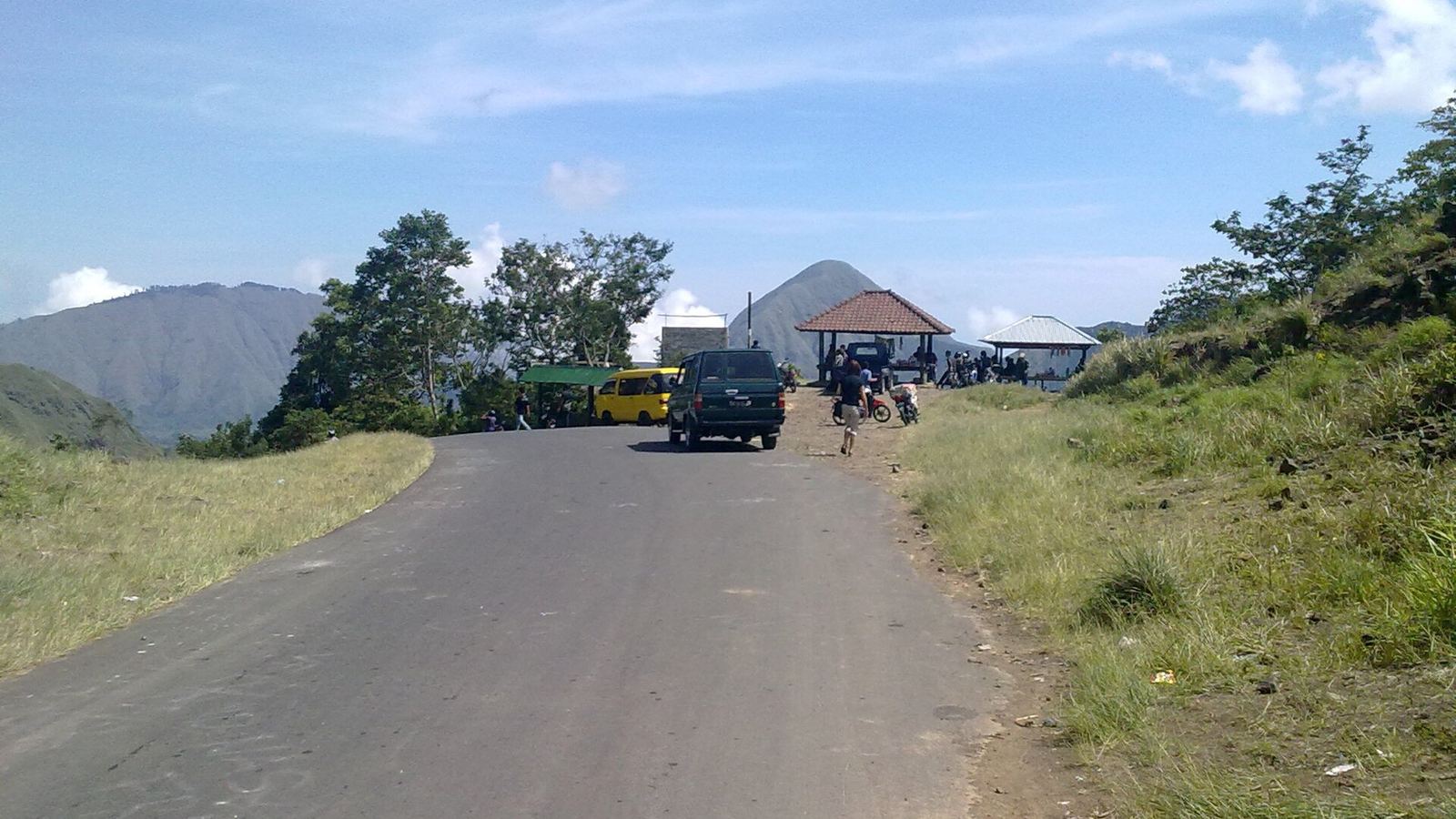 Road at the Pusuk pass between Sapit and Sembalun, Lombok, with a car, a minibus and a small viewpoint