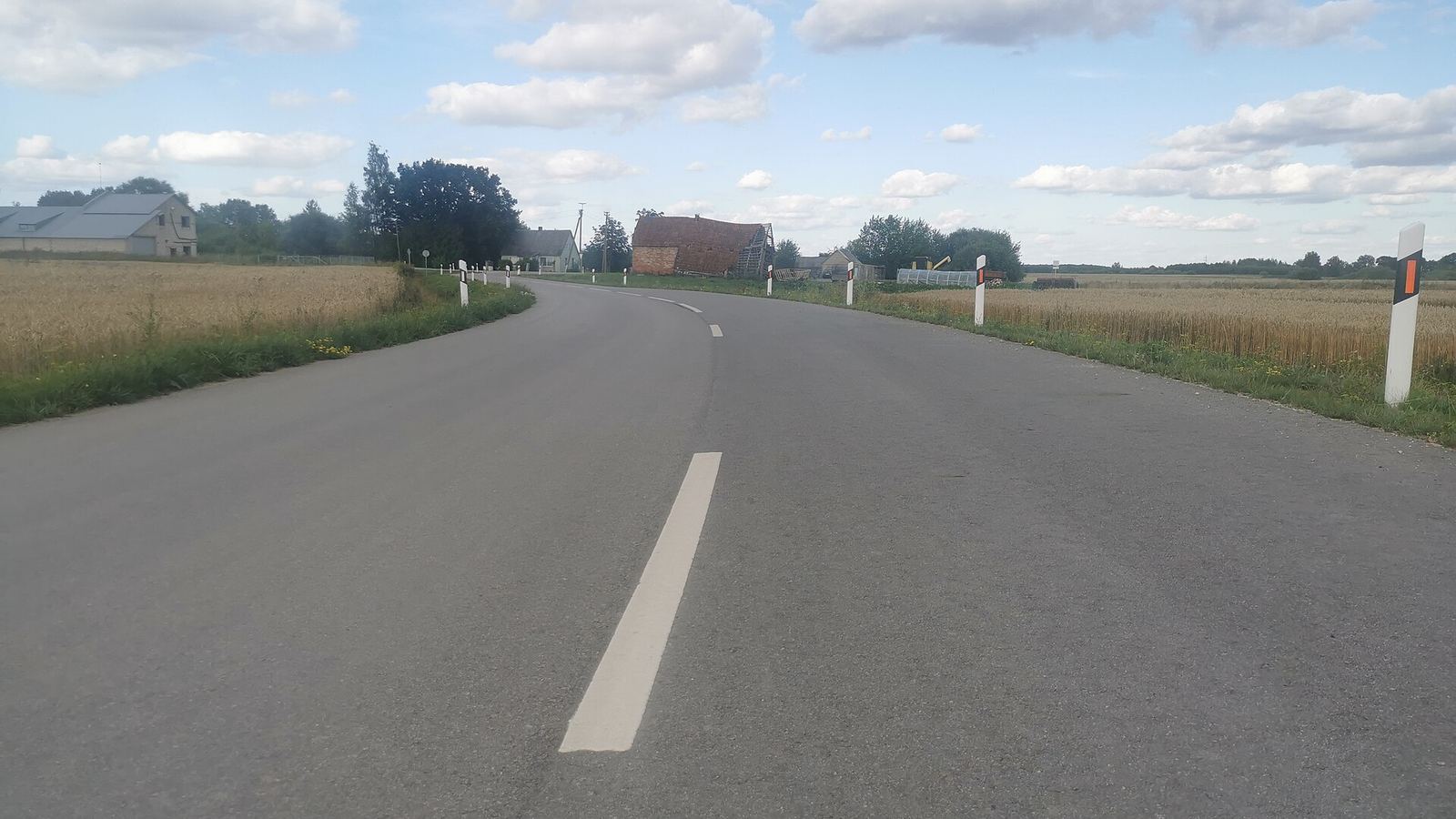 Rural road between wheat fields near Pervalkai