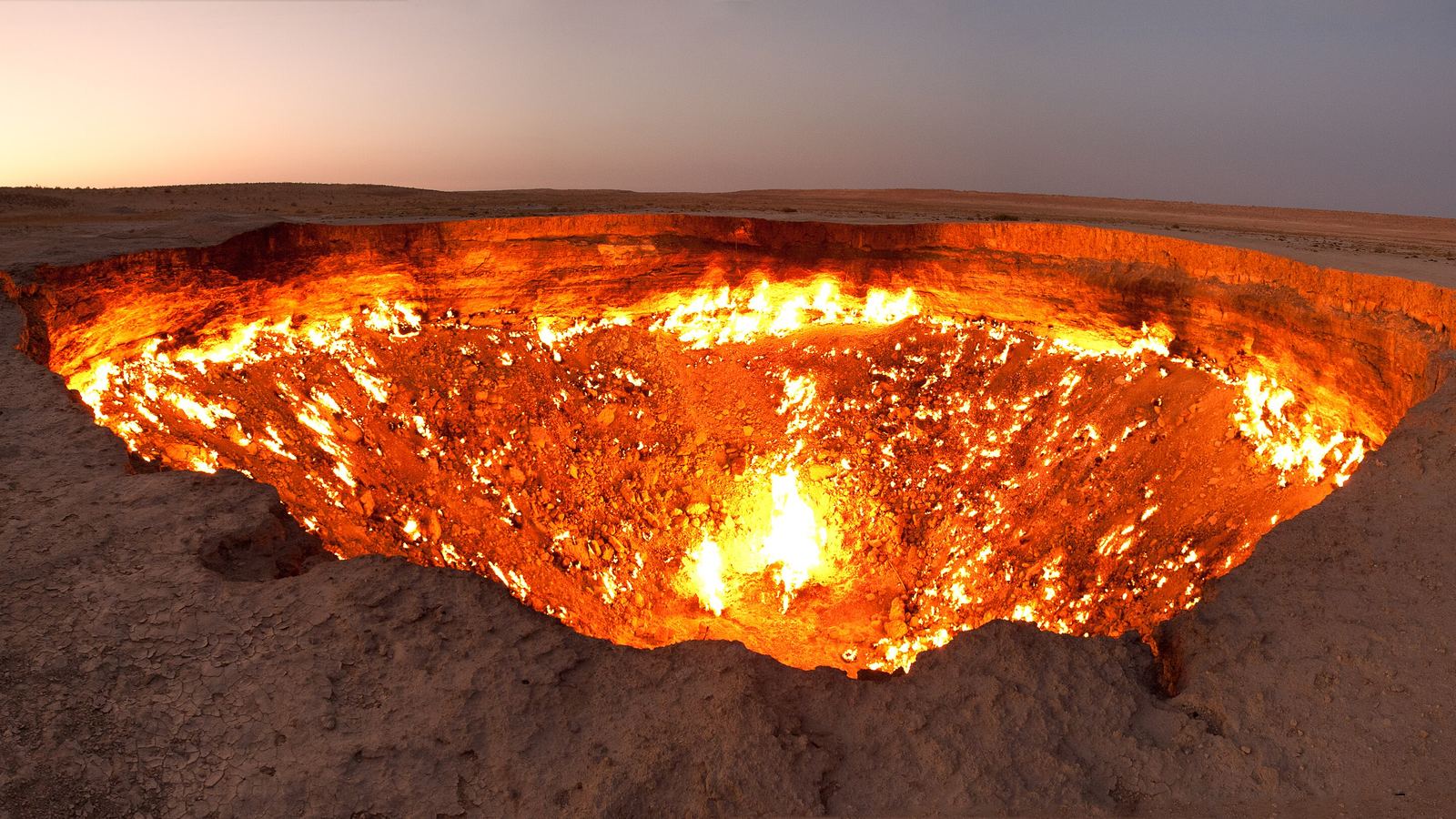 The Darvaza gas crater (Door to Hell) burning at dusk in the Karakum Desert